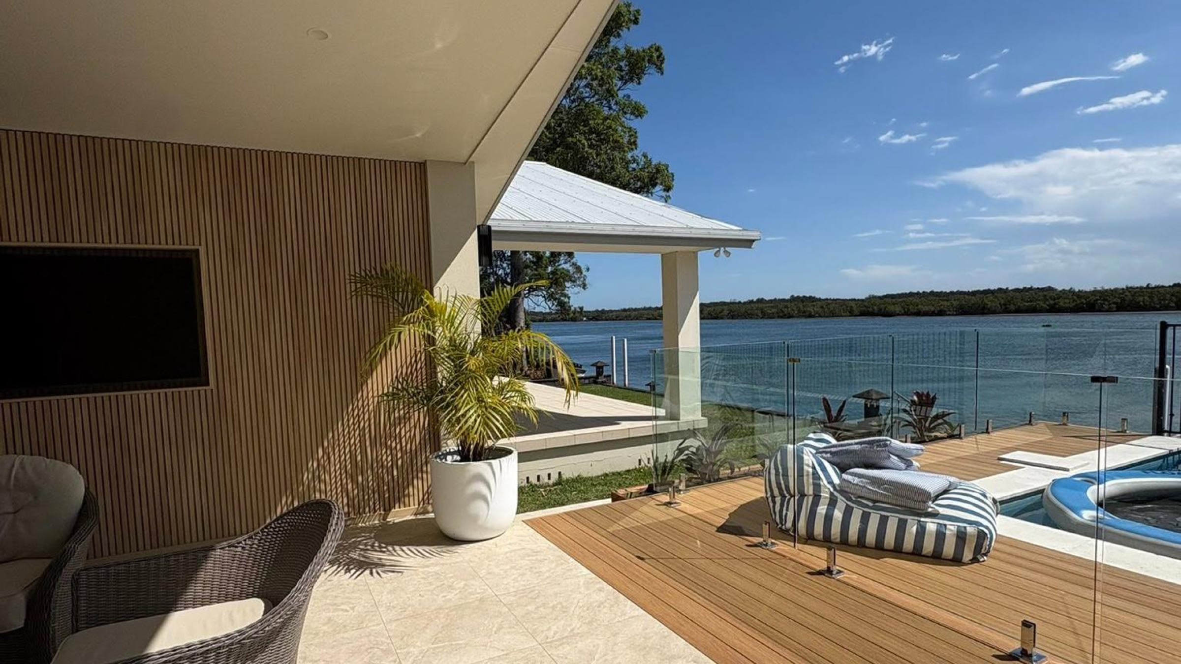 A timber deck and lounge overlooking the water