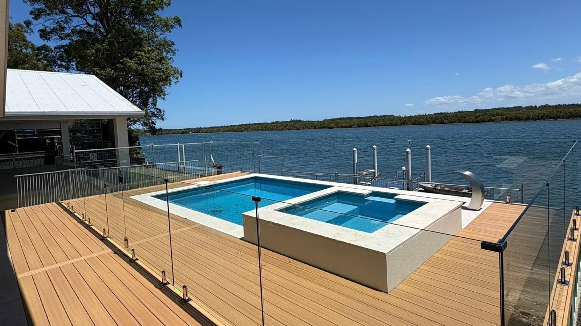 A pool deck overlooking the water at a Port Macquarie property
